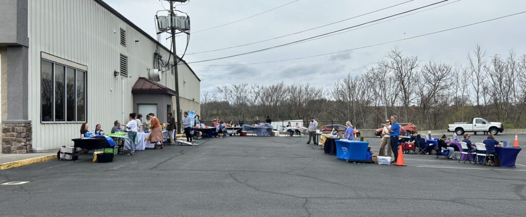 Event booths are scattered around an empty parking lot on a cloudy day